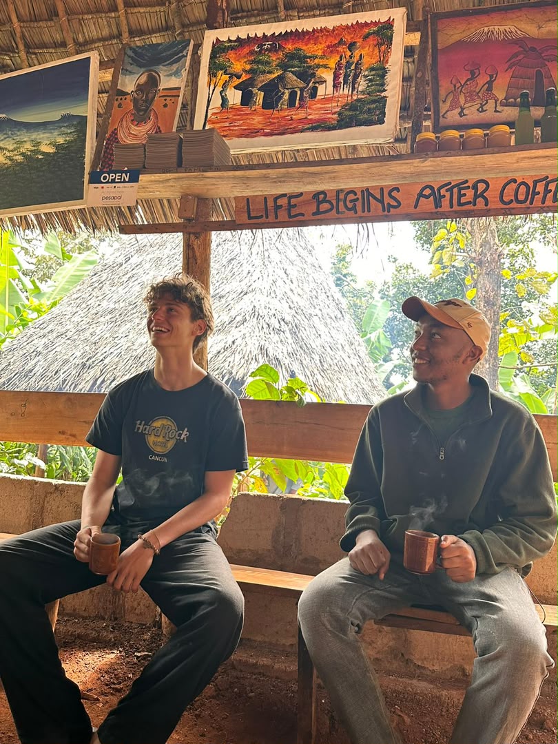 A warm cultural moment with coffee and Tanzanian artwork in the background